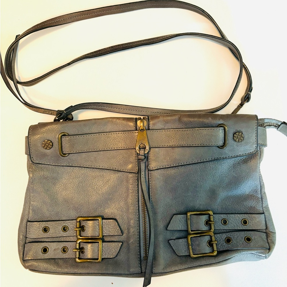 Gray Joelle Hawkins leather messenger bag brass buckles